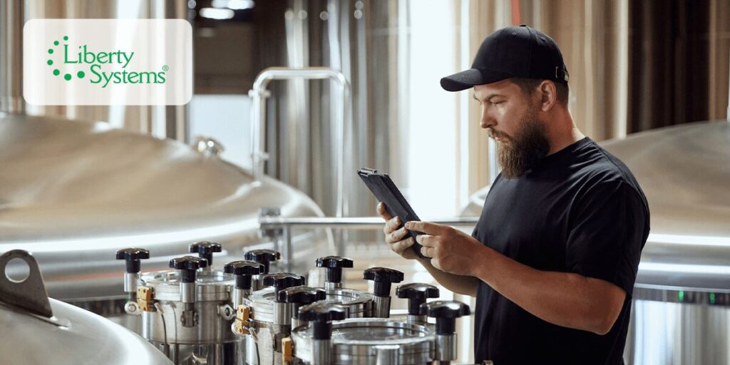 Man standing inside a brewery learning how to reduce dissolved oxygen